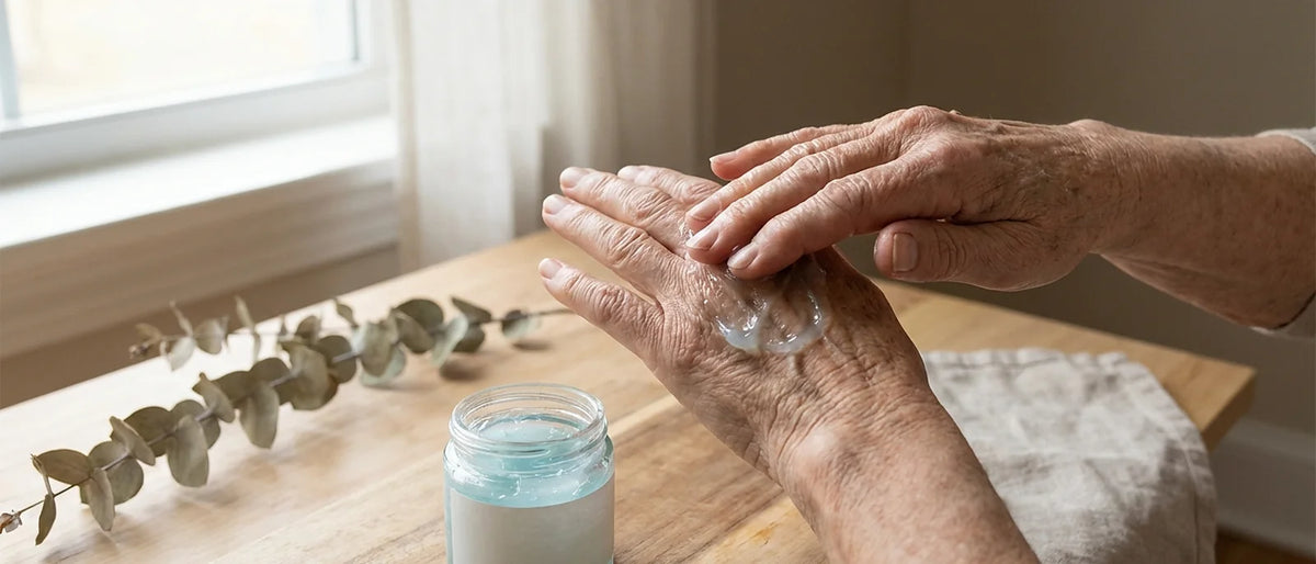 Elderly hands gently massaging knuckles with cooling gel for arthritis relief