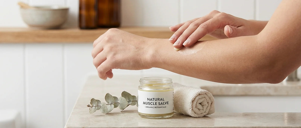 Hands applying a small amount of natural muscle salve efficiently, demonstrating proper technique for making premium products last longer