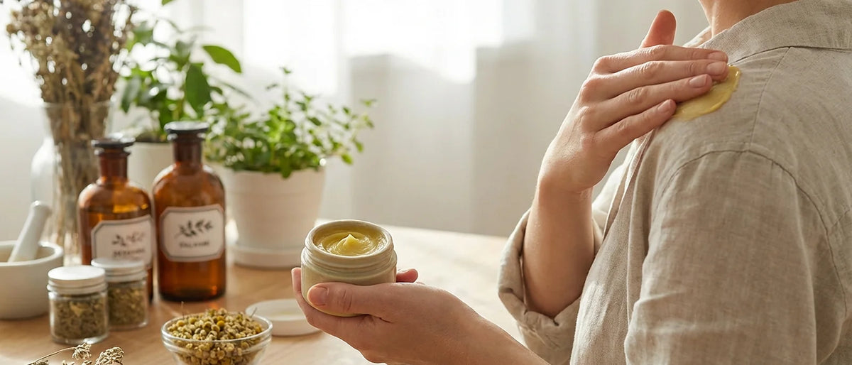 Person applying natural healing salve to shoulder for bursitis relief