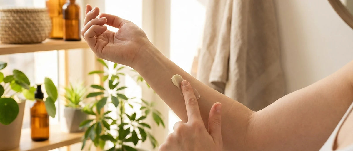 Woman's inner forearm with small amount of natural cream being applied for patch test, gentle lighting