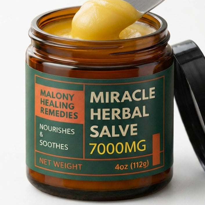 Jar of Miracle Herbal Salve with a spoonful of salve on a white background